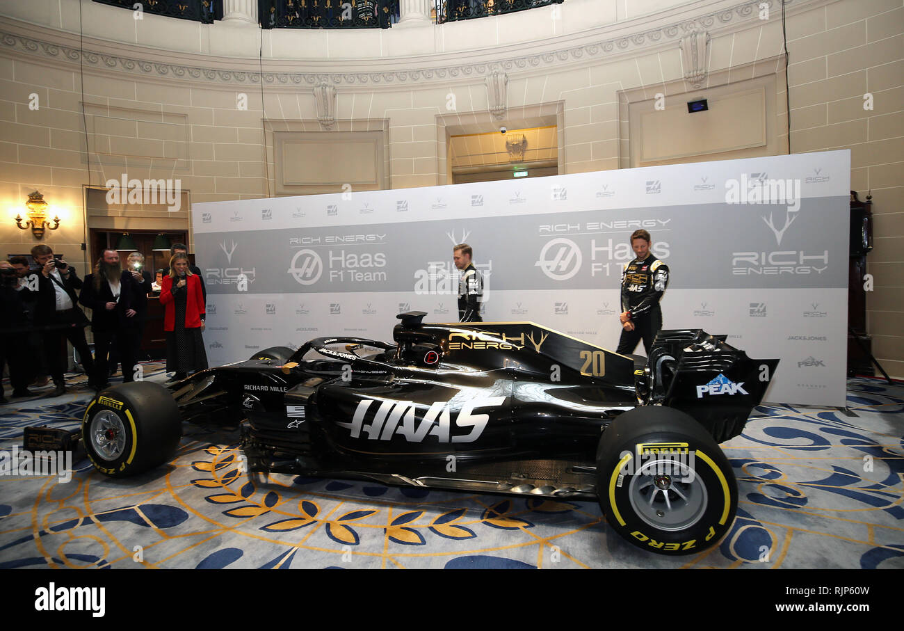 Kevin Magnussen and Romain Grosjean survey the new livery during the Rich Energy Haas F1 Team 2019 car launch at the Royal Automobile Club, London. Stock Photo