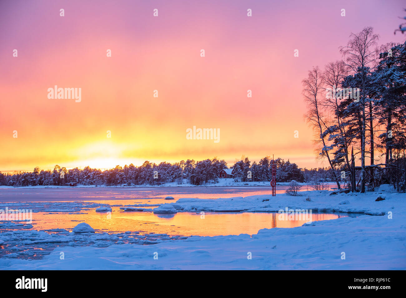 Striking sunset over partially frozen Haukilahti bay, Espoo, Finland, Europe Stock Photo