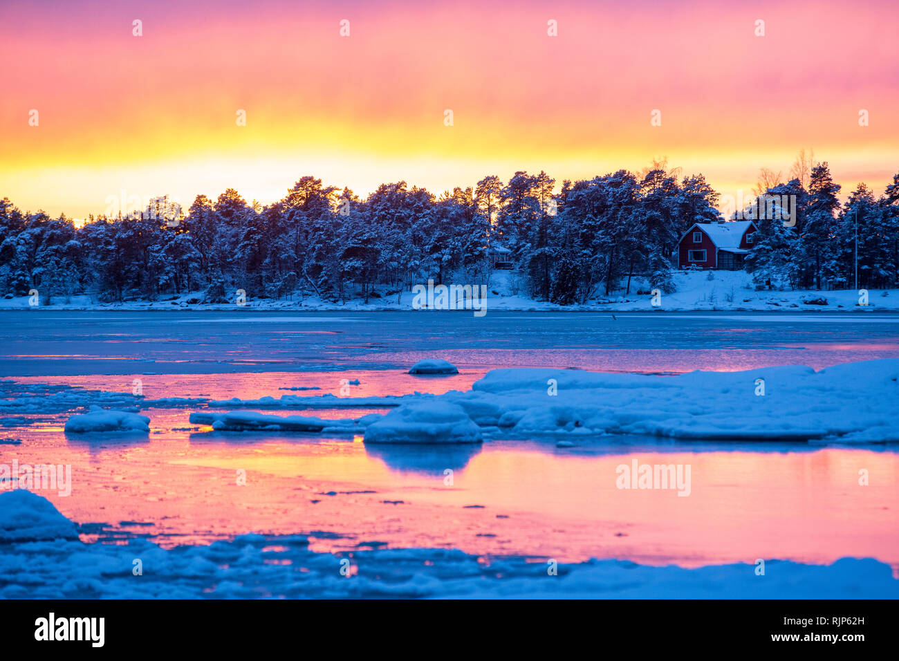 Striking sunset over partially frozen Haukilahti bay, Espoo, Finland, Europe Stock Photo
