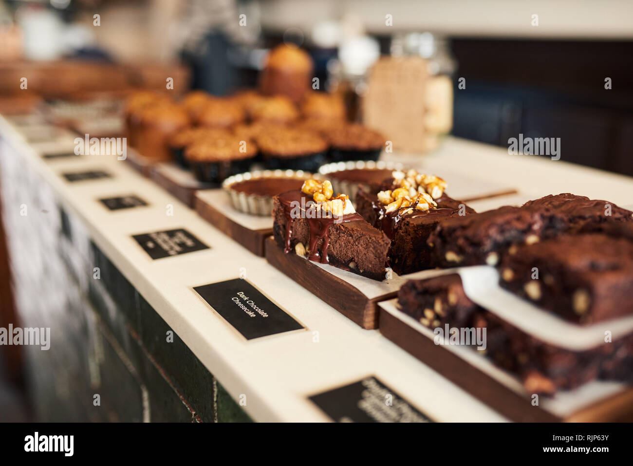 Assortment of delicious desserts in a bakery's glass display case Stock Photo