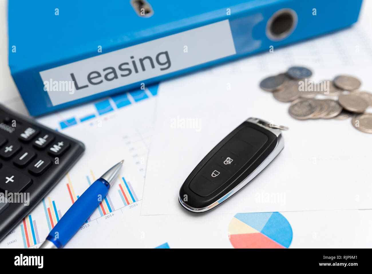 Car keys, remote control, binder with leasing label. Car leasing concept Stock Photo