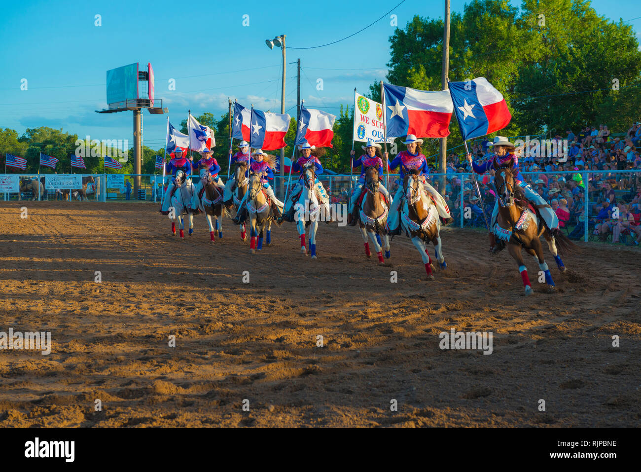 Lone Star Cowgirls entertaining a Texas Pro Rodeo Crowd Stock Photo