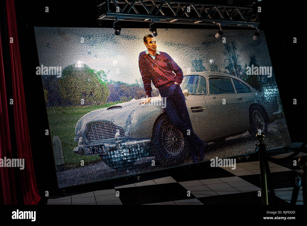 A Lego mosaic of Sean Connery posing with a 1964 Aston Martin DB5 created by Ryan McNaught aka The Brickman Stock Photo
