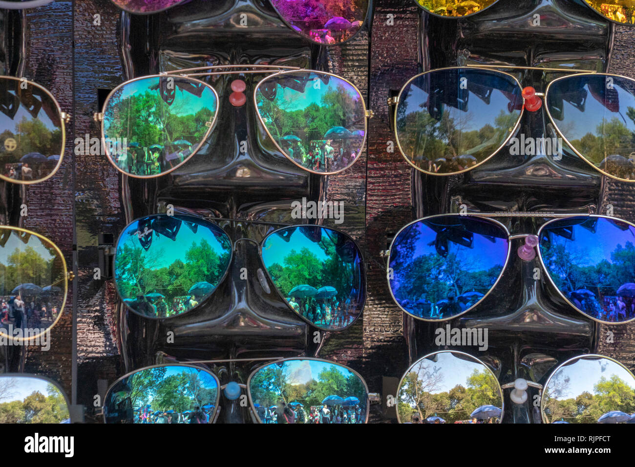 many sunglasses on display stand for sale at the market Stock Photo Alamy