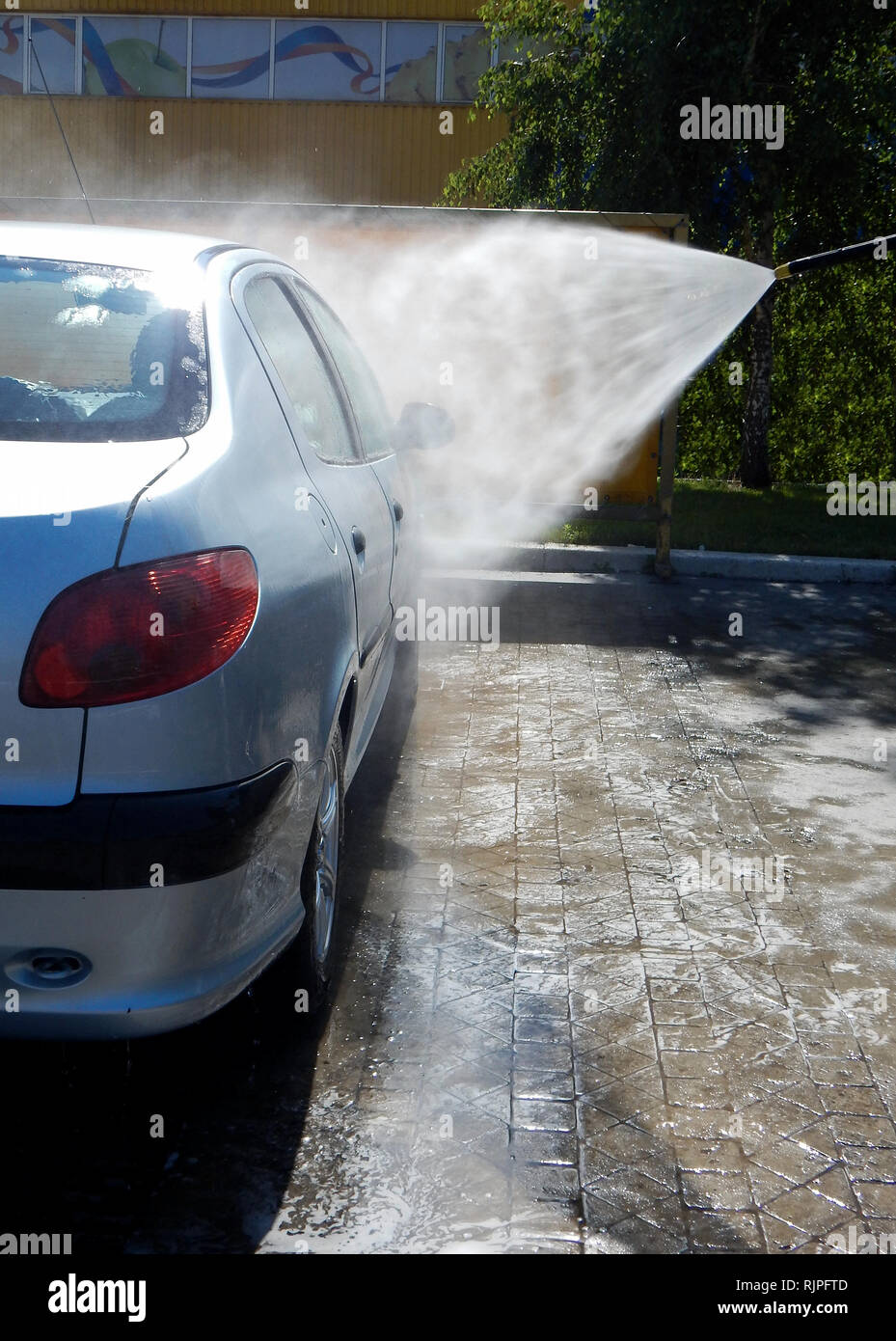Car washing by high pressure jet washer Stock Photo