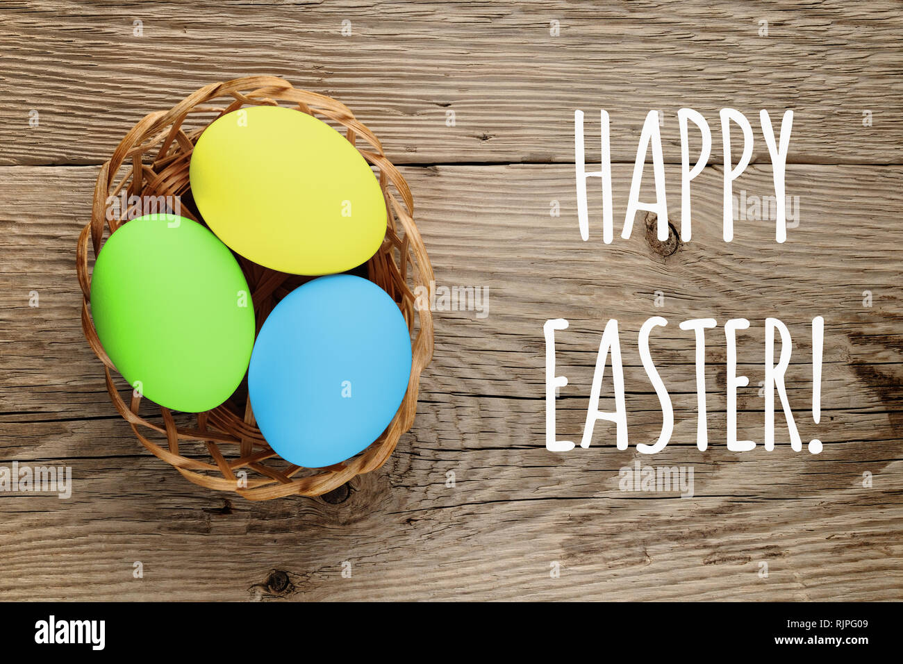 Happy Easter text and easter eggs on wooden background Stock Photo Alamy Happy Easter text and easter eggs on wooden background Stock Photo Alamy