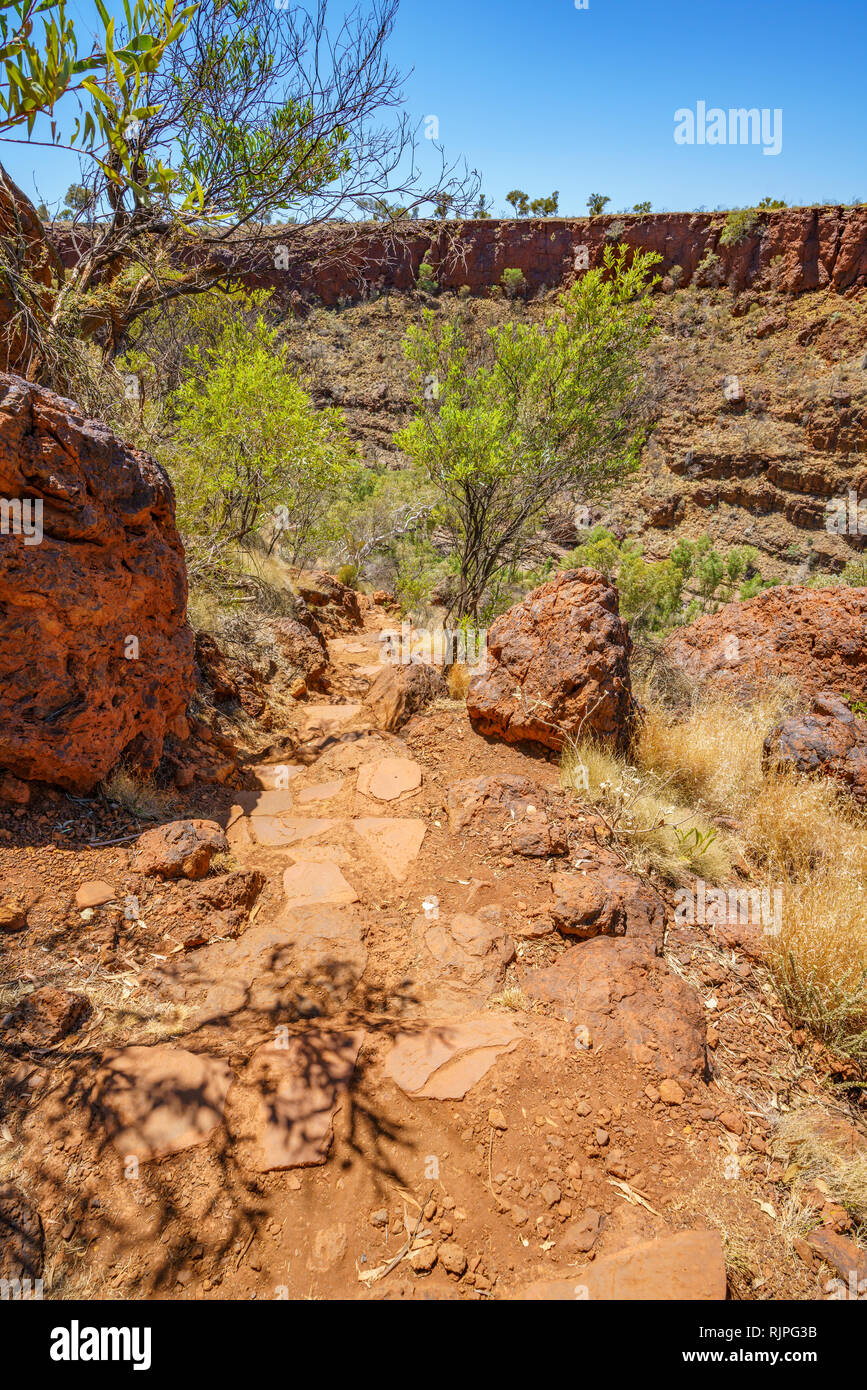 hiking over rocks in dales karijini national park, western
