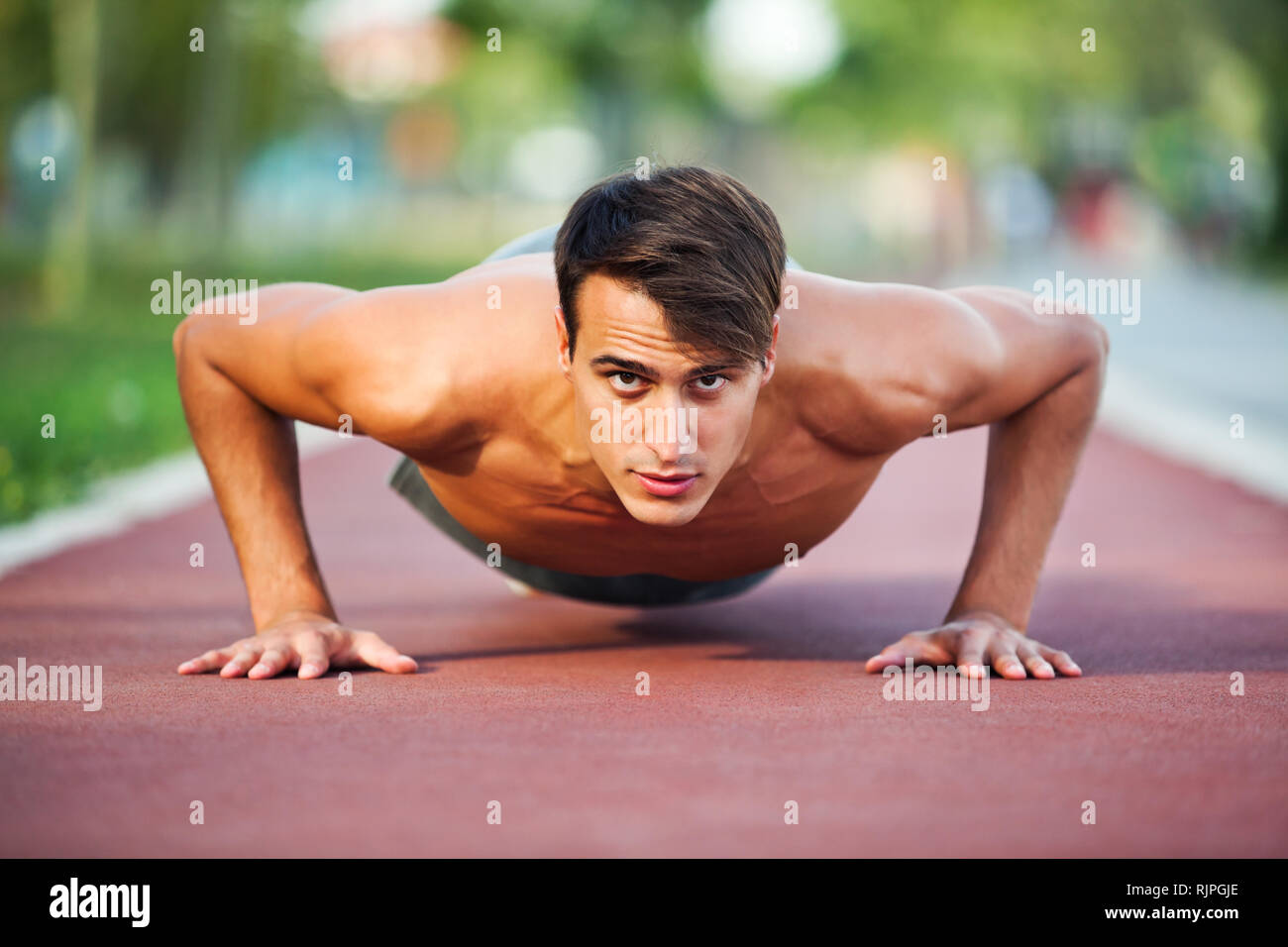 Young man exercising outdoor, doing push-ups Stock Photo - Alamy