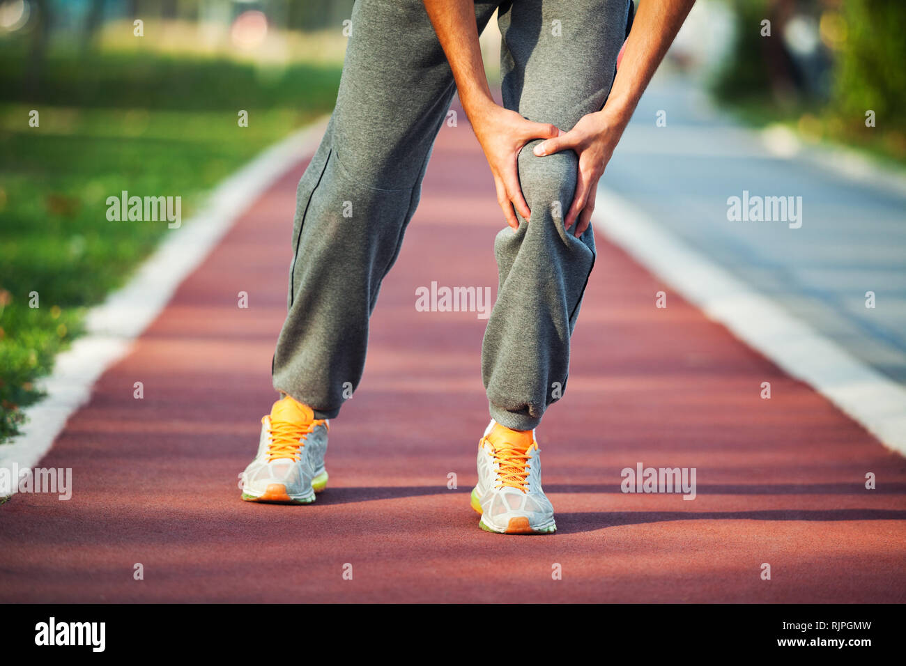 Man having pain in leg while jogging Stock Photo Alamy