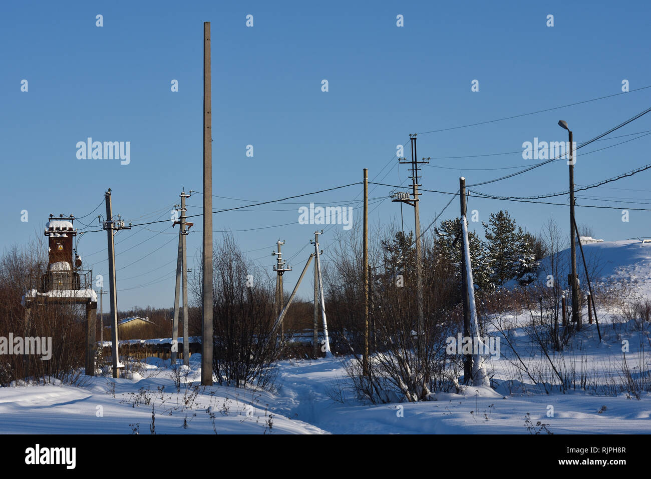 Electric poles away from the village Stock Photo - Alamy