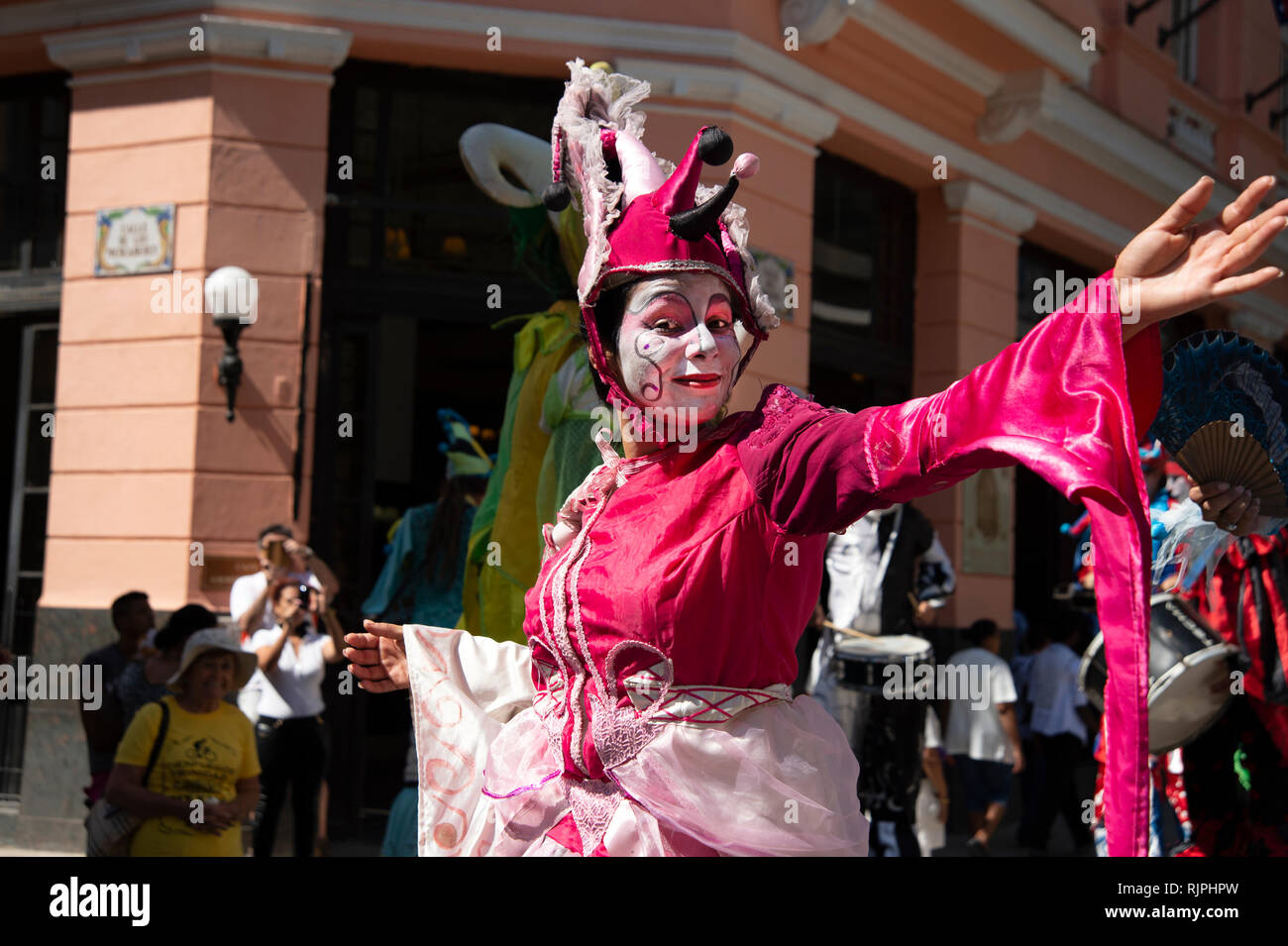 A female street entertainer dressed in costume performs for the crowds in Havana Cuba Stock Photo