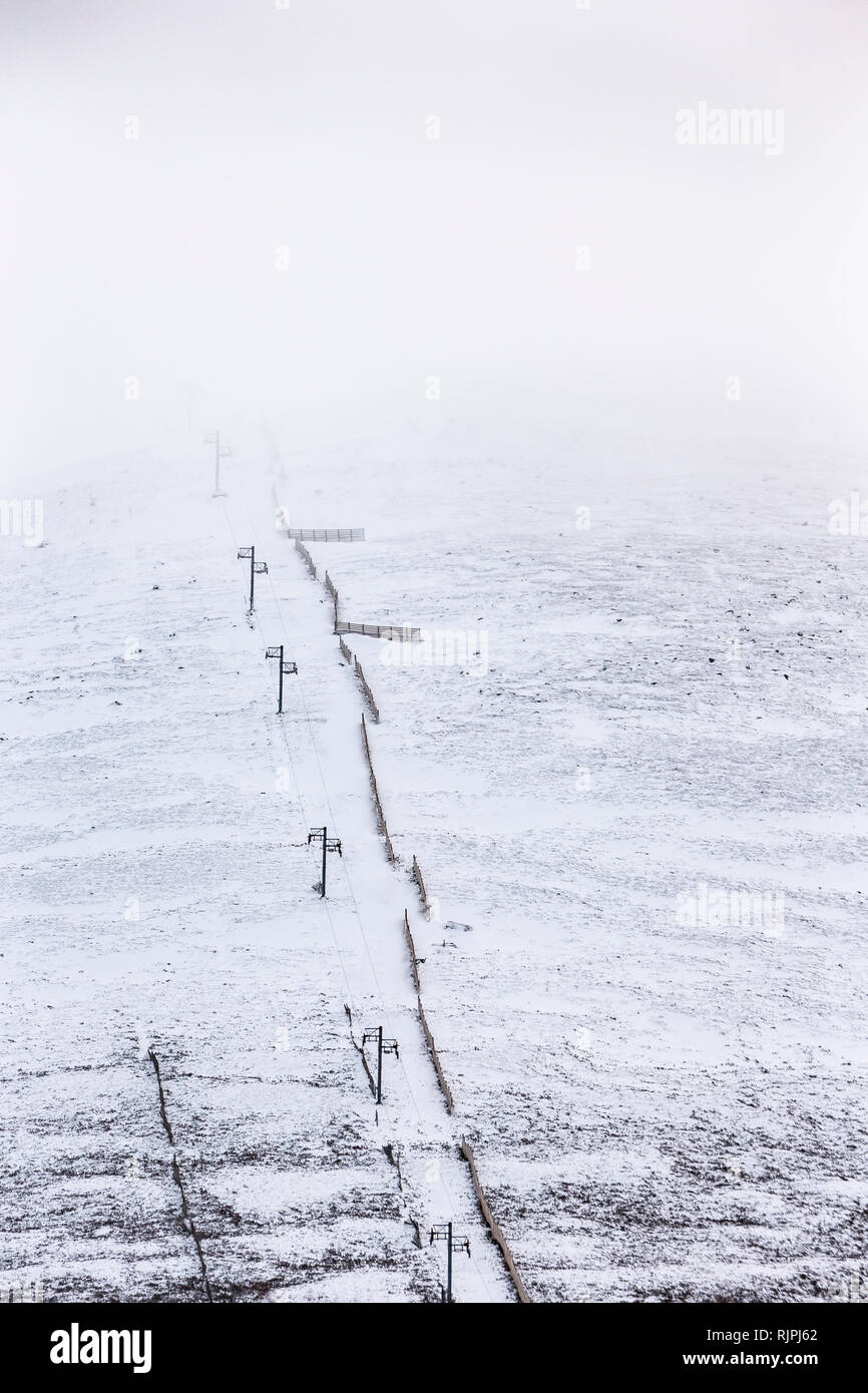 Ski lift and Snow fence on Cairngorm Mountain in Scotland. Stock Photo