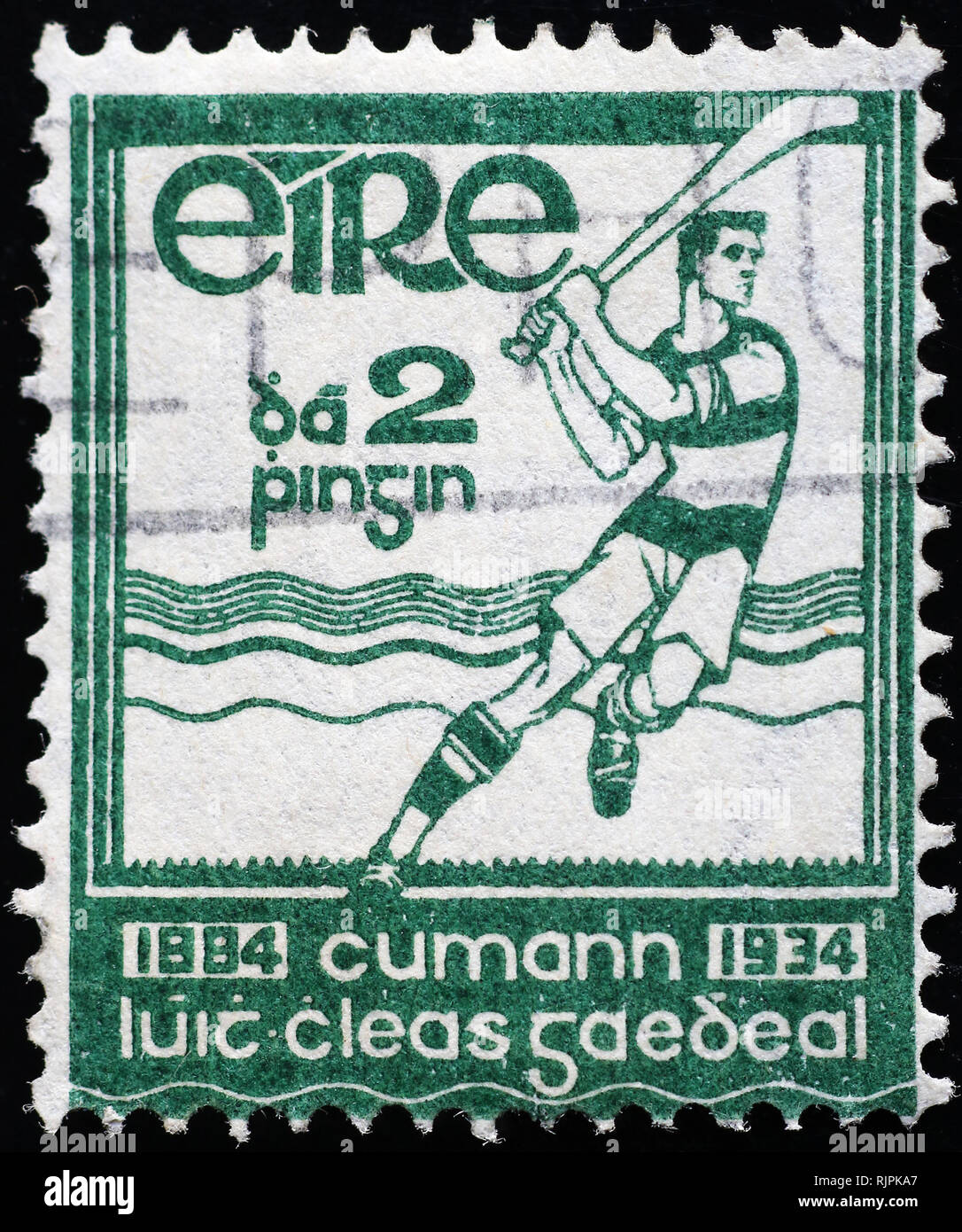 Field hockey player on ancient irish postage stamp Stock Photo