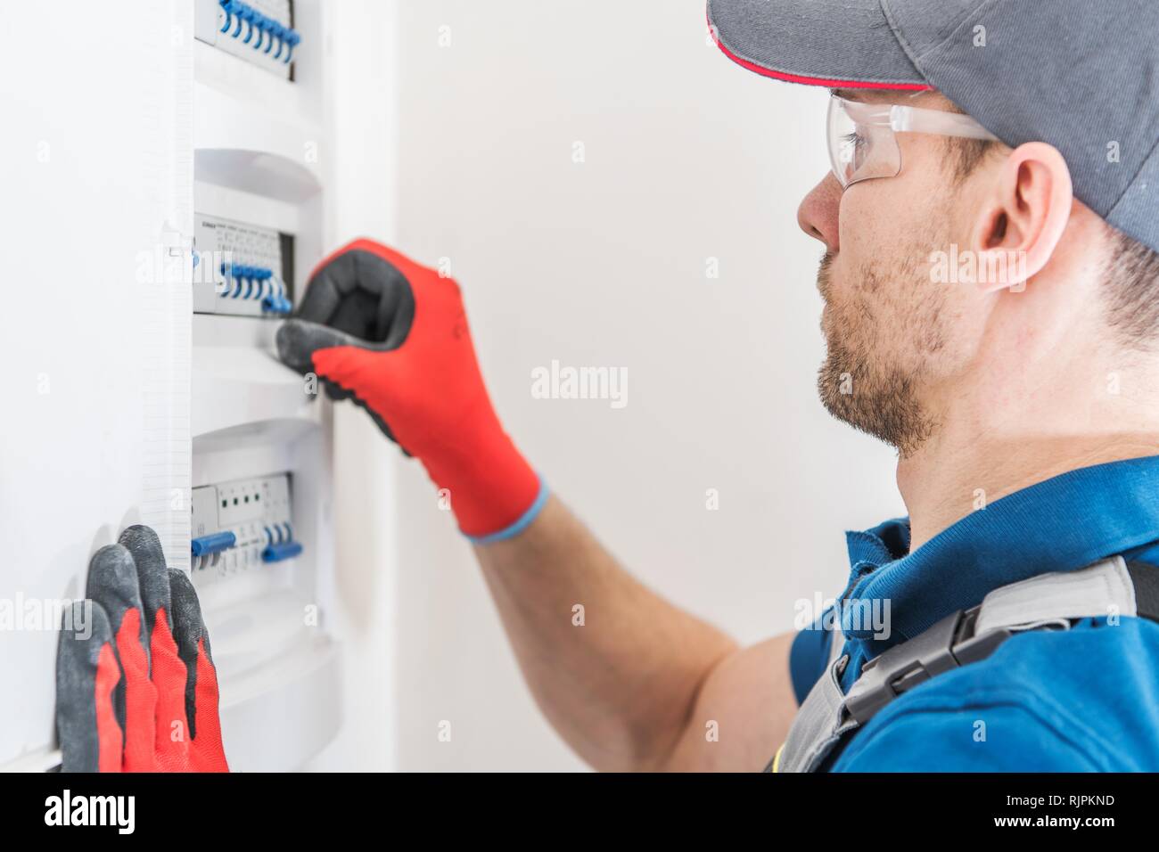 Electric Residential Fuses Box Check by Caucasian Electrician Stock