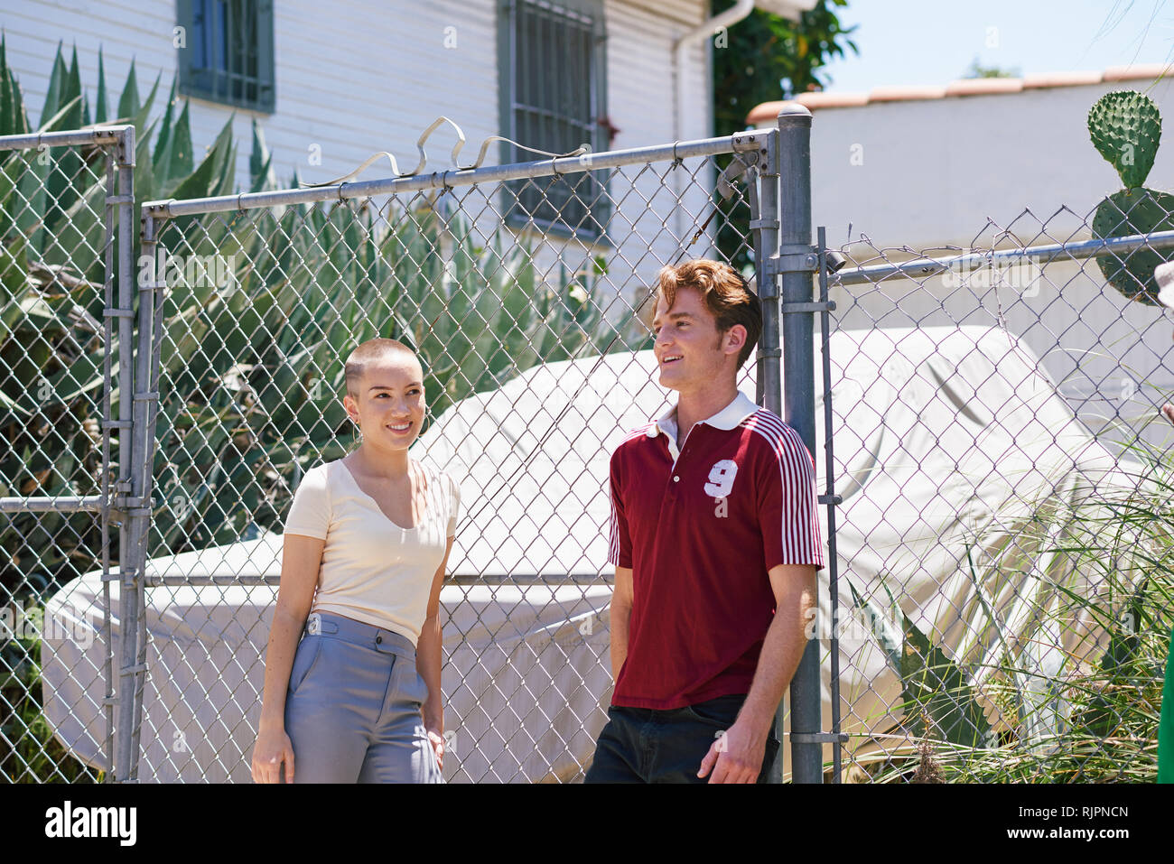 Young man and teenage girl on suburban sidewalk, Los Angeles, California, USA Stock Photo