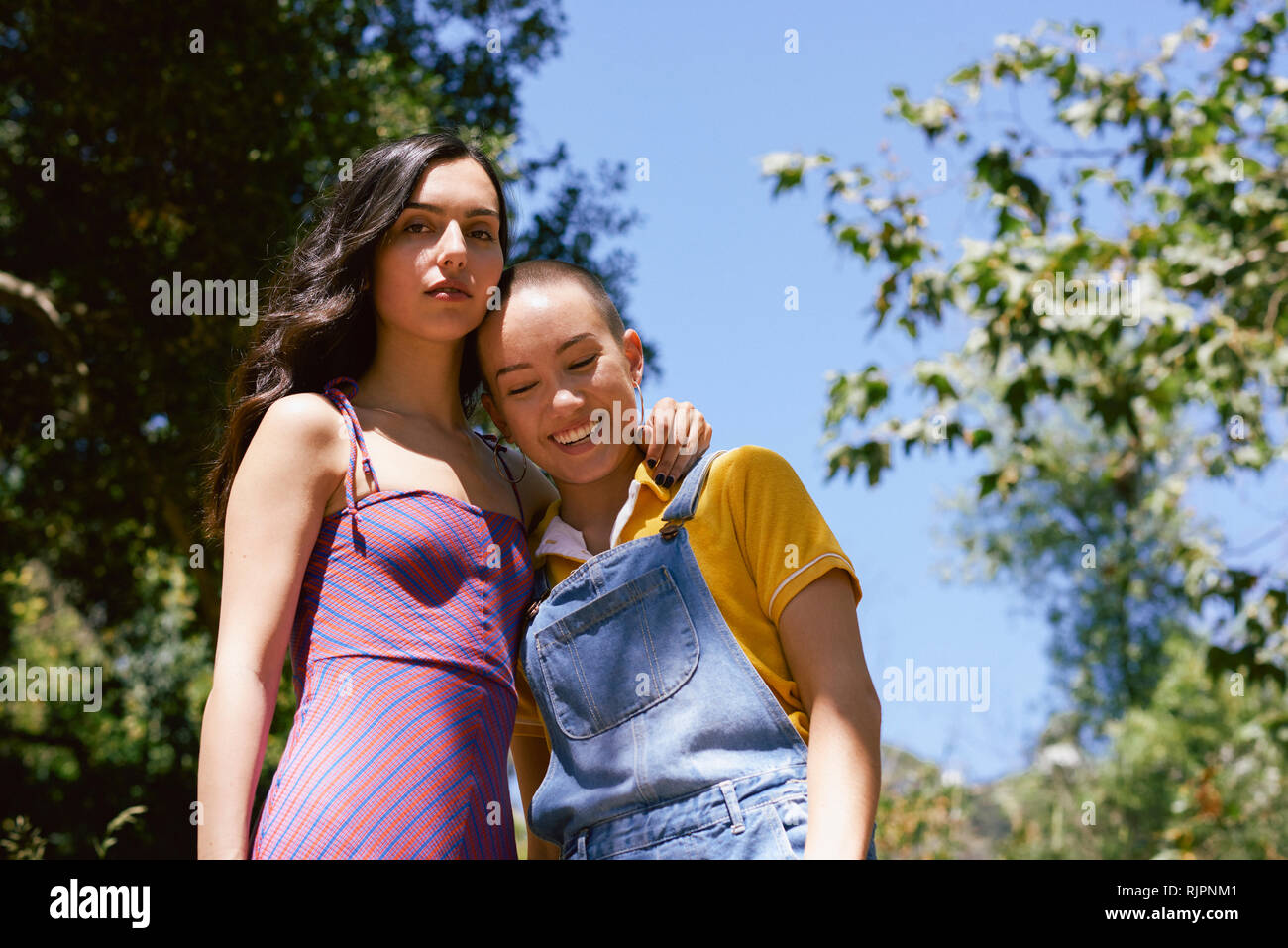 Two young female friends in park, portrait, Los Angeles, California, USA Stock Photo