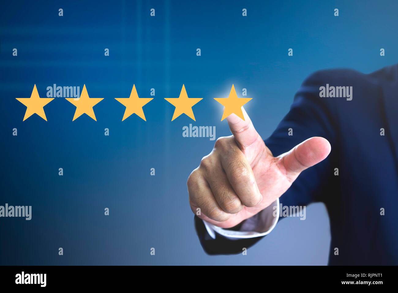 Hand of a man giving high score with five golden stars rating for movie or television programme or anything that having the required qualities. Show t Stock Photo