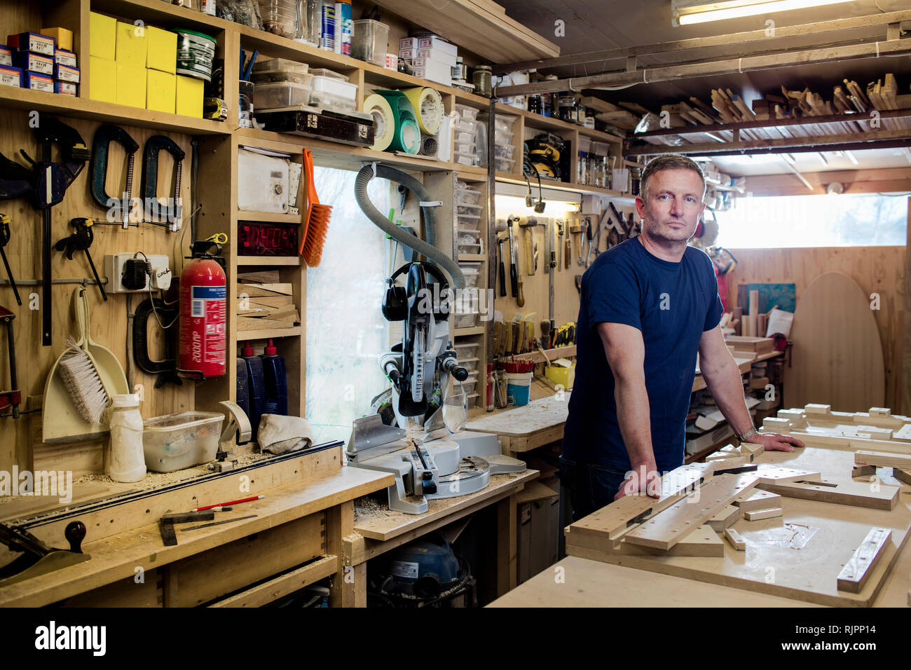 Craftsman beside his workbench and tools Stock Photo