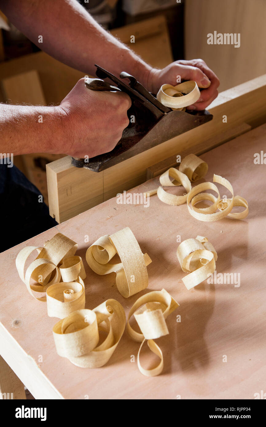 Craftsman using wood plane in Stock Photo Alamy