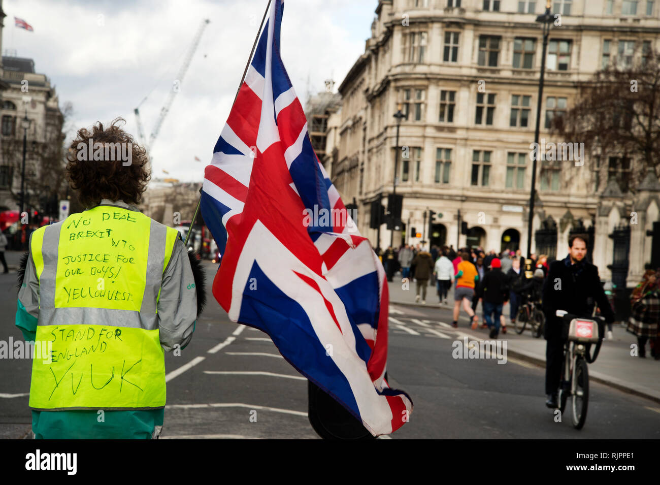 London.Westminster. February 7th 2019. A lone pro Brexit protester waves a Union Jack in the middle of the road Stock Photo
