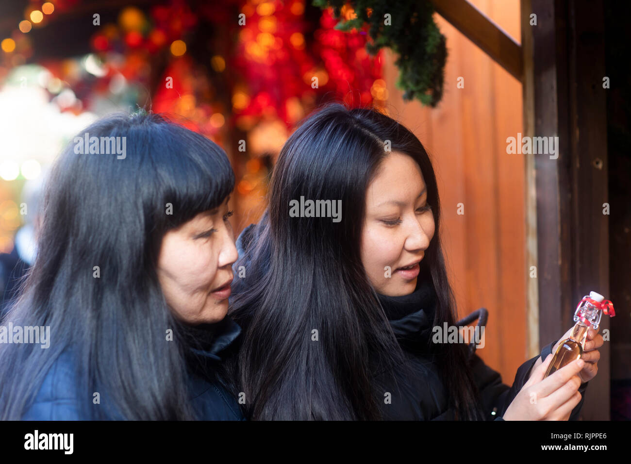 Mother and daughter window shopping at Christmas market, Freiburg, Baden-Wurttemberg, Germany Stock Photo