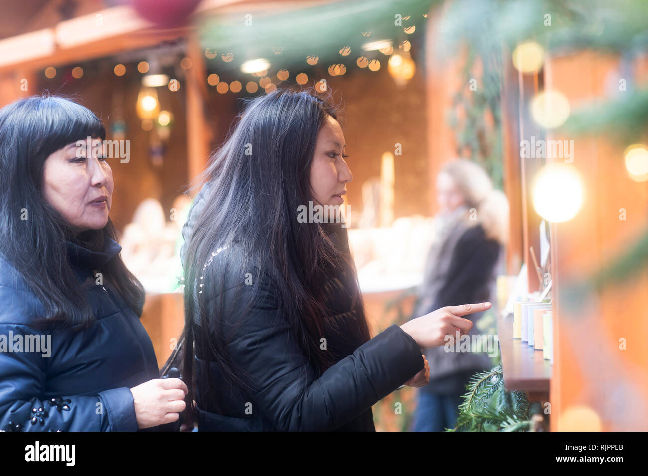 Mother and daughter window shopping at Christmas market, Freiburg, Baden-Wurttemberg, Germany Stock Photo