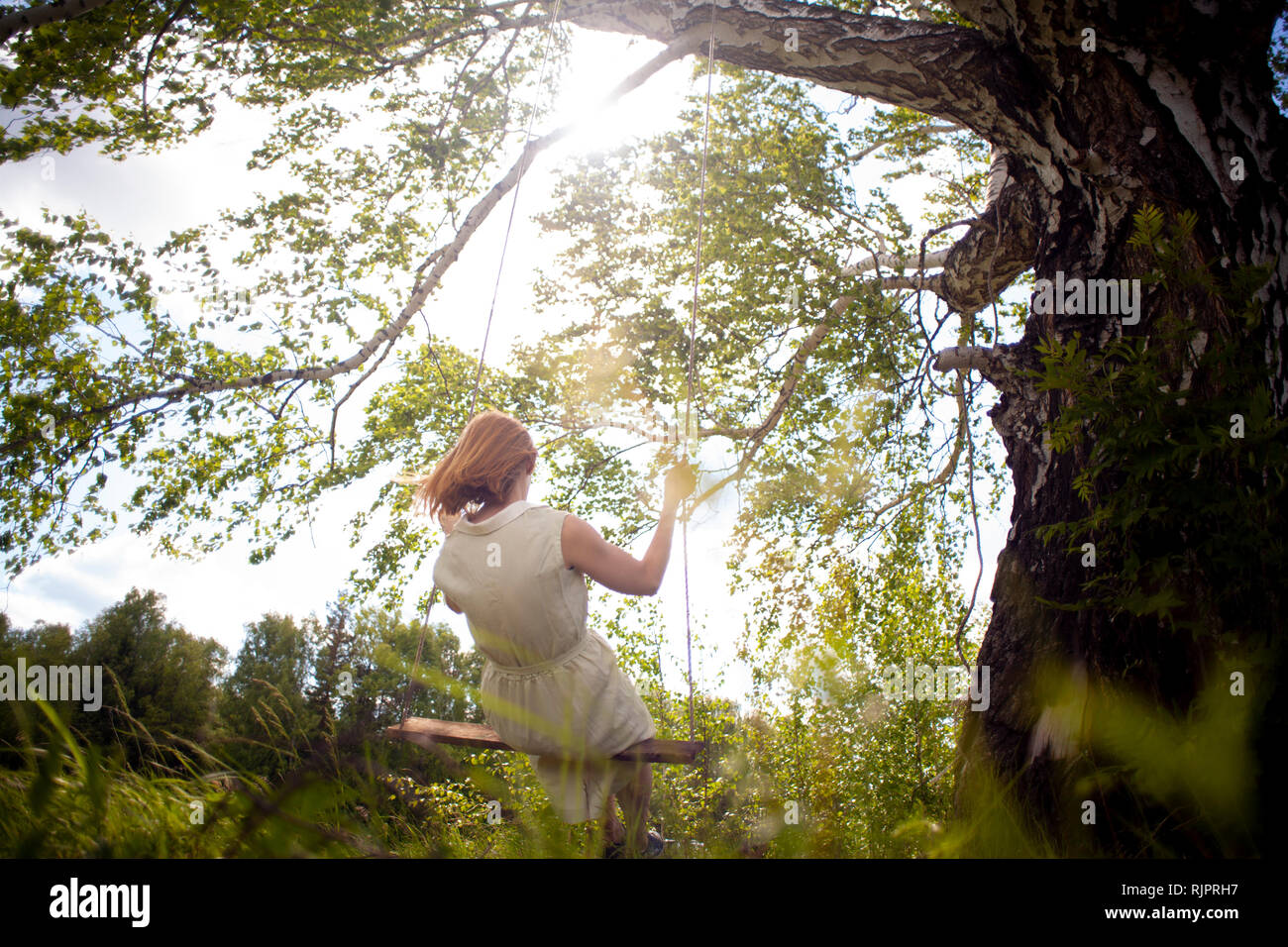Woman on swing hi-res stock photography and images - Alamy