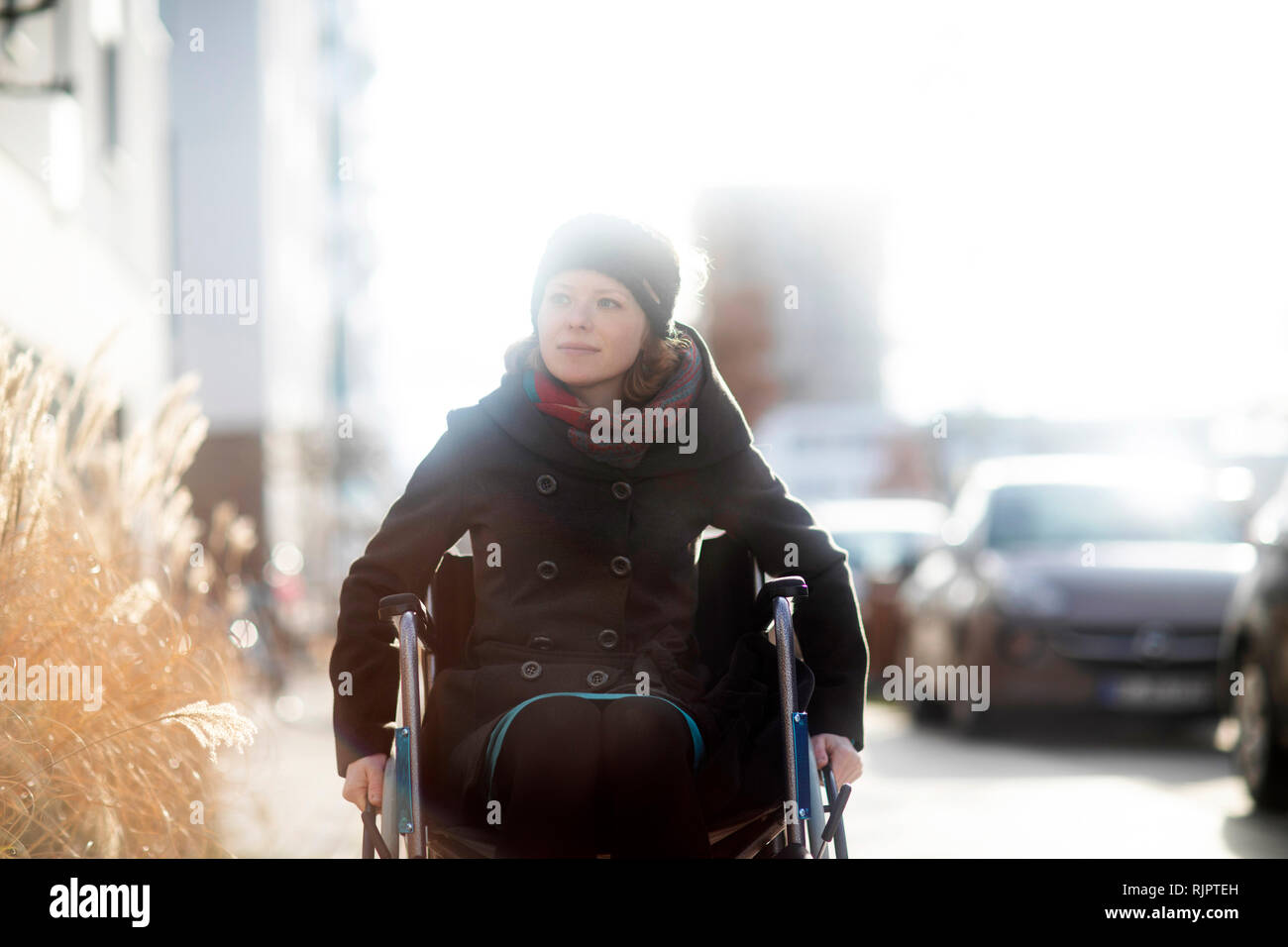 Woman in wheelchair in street Stock Photo