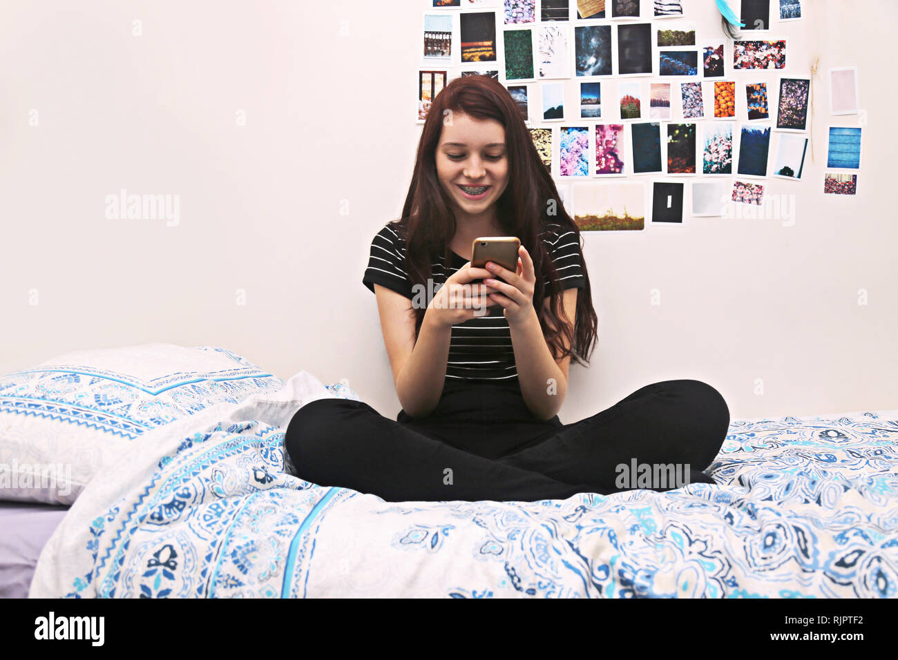 Teenager social networking on bed Stock Photo