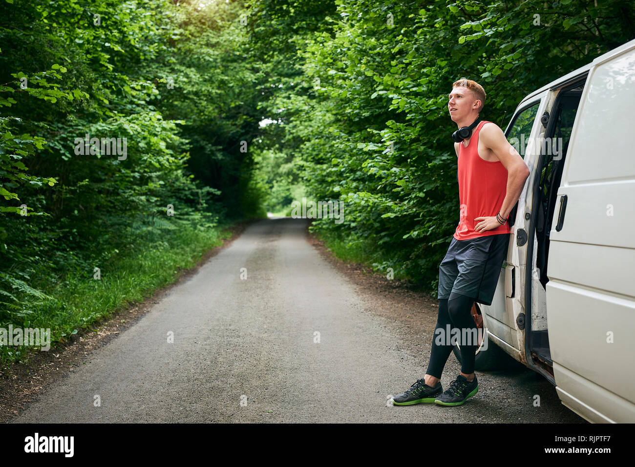 Runner leaning on van Stock Photo