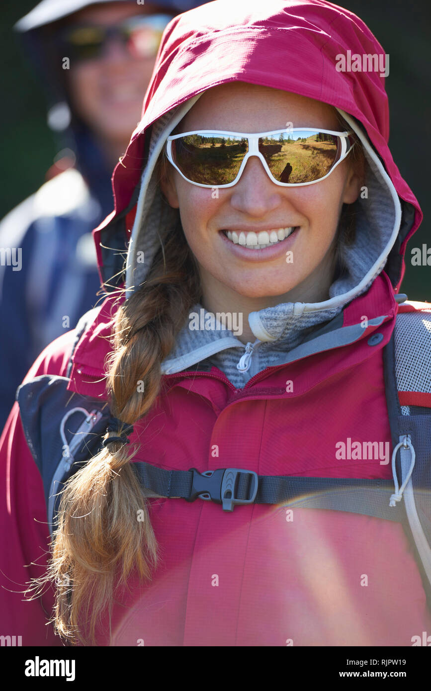 Hikers in hooded jacket and sunglasses Stock Photo