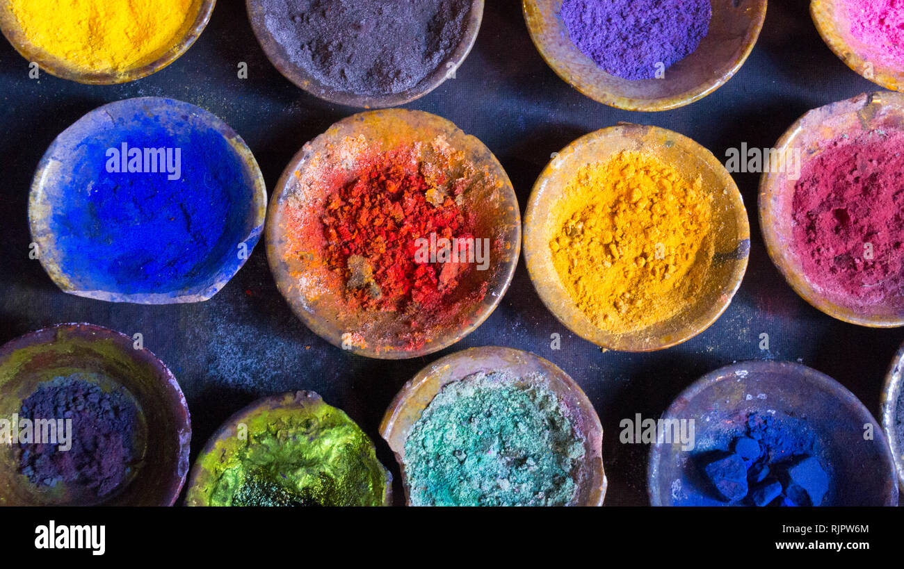 Vibrant pigment powder in clay dishes Stock Photo