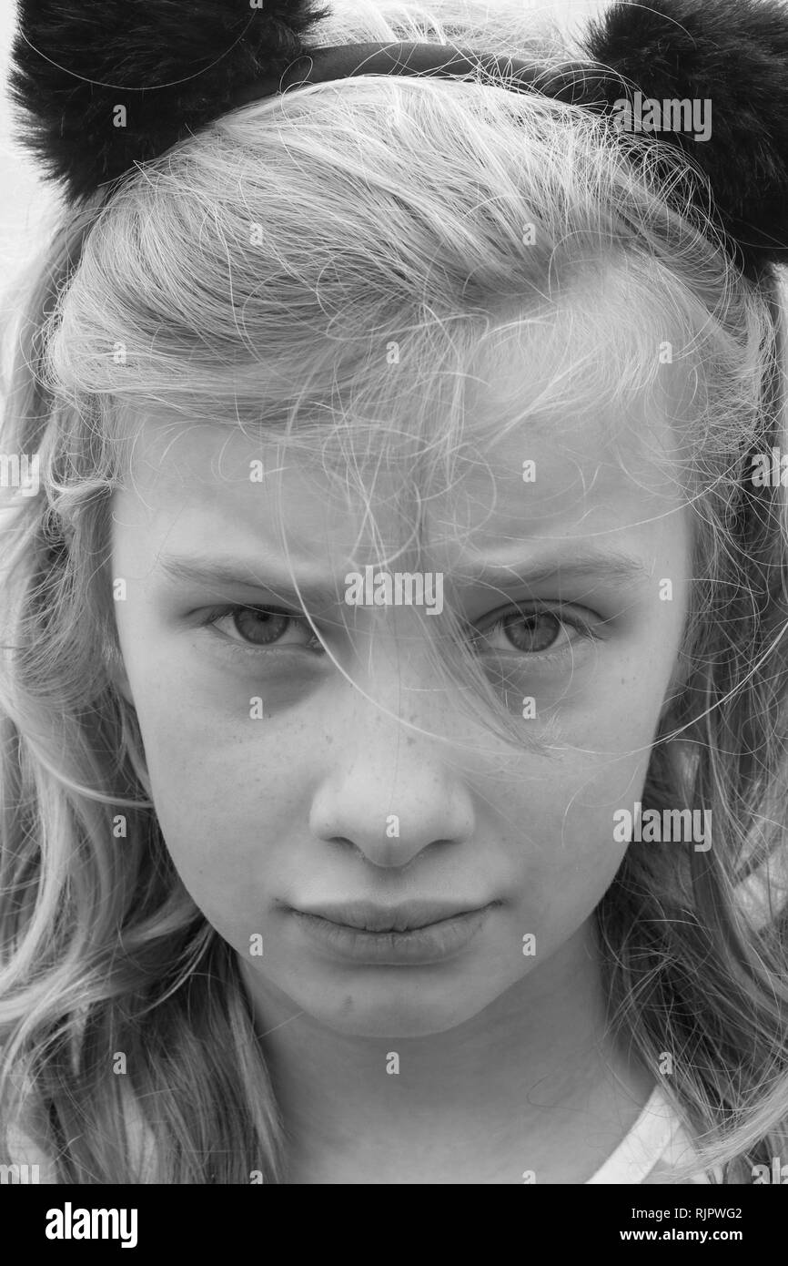 Black and white portrait of an unhappy, sad, hurting, preteen girl Stock Photo