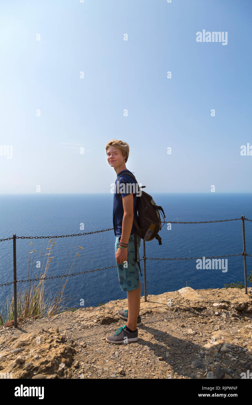 Teenage boy on coast, full length portrait, Vernazza, Liguria, Italy Stock Photo