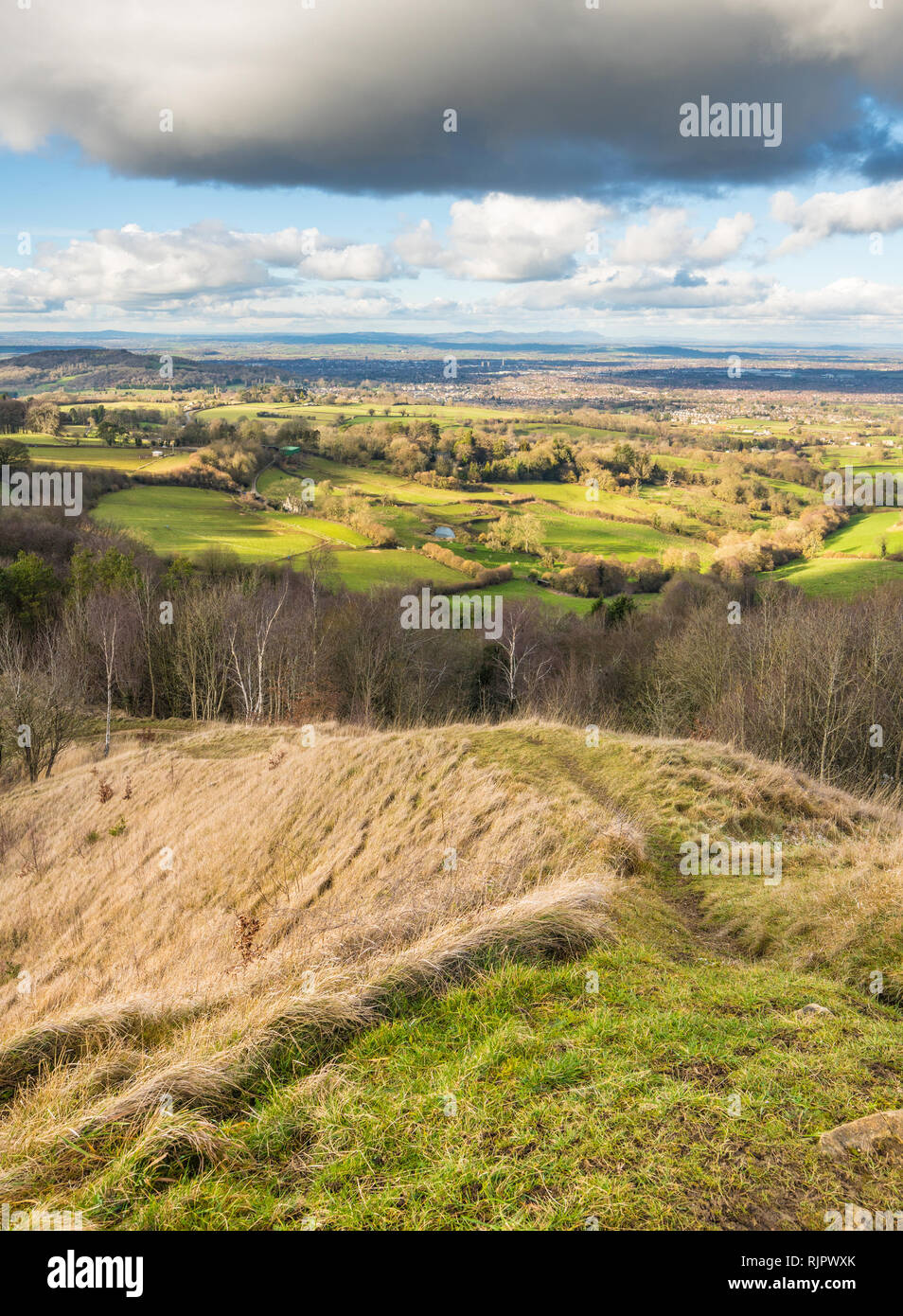 View from the summit of Painswick Beacon in the Cotswolds, Goucestershire, UK. Standing on the hill fort looking out across the plain of the river Sev Stock Photo