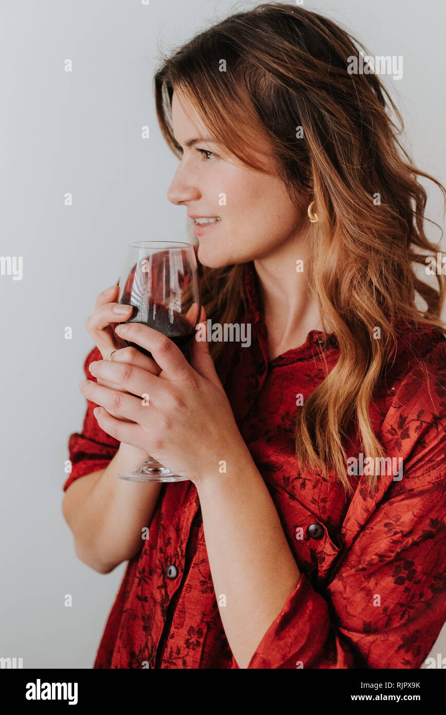 Woman holding glass of wine, white background Stock Photo - Alamy