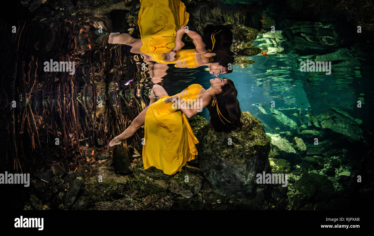 Woman in yellow gown floating underwater, Cenote, Quintana Roo, Mexico Stock Photo Alamy