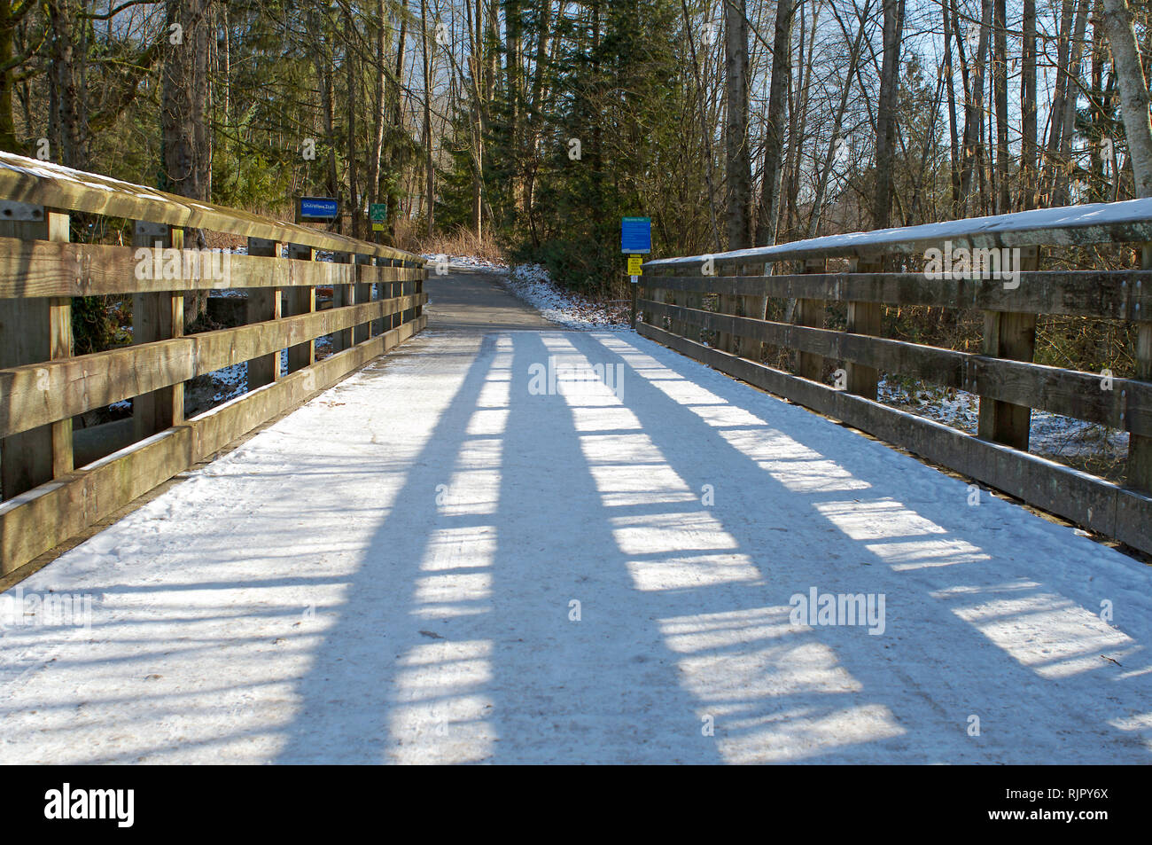 Snow-covered foot bridge along the trail in Shoreline Park, Rocky Point, Port Moody, British Columbia, Canada. Stock Photo