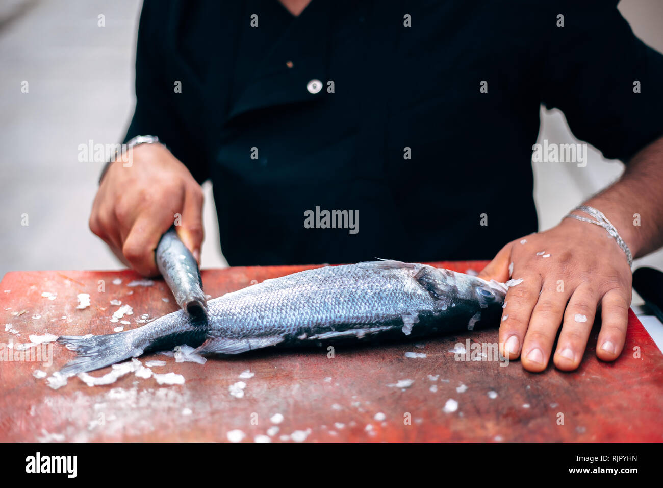 Chef Cleaning fish scale flake in Fish Restaurant Stock Photo Alamy
