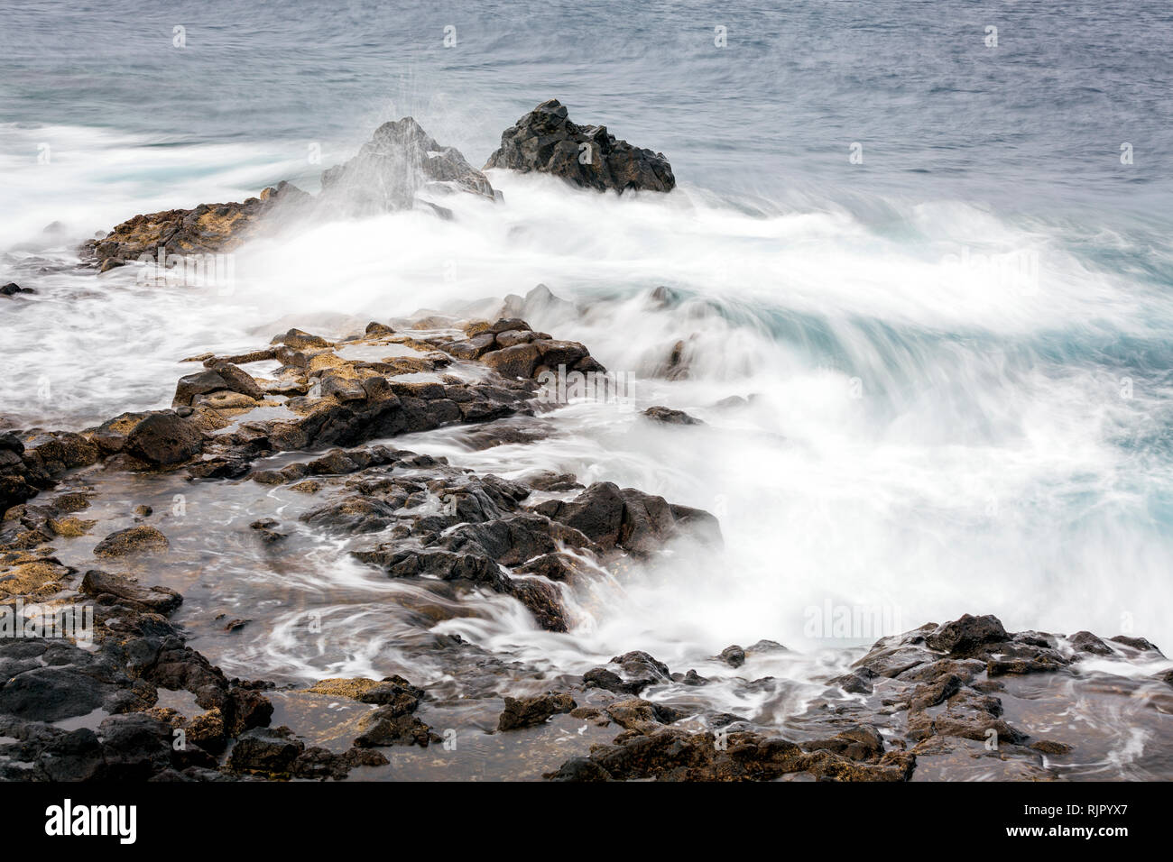 Rough seas swirling around rocks on the east coast of Tenerife, Canary Islands, Spain Stock Photo