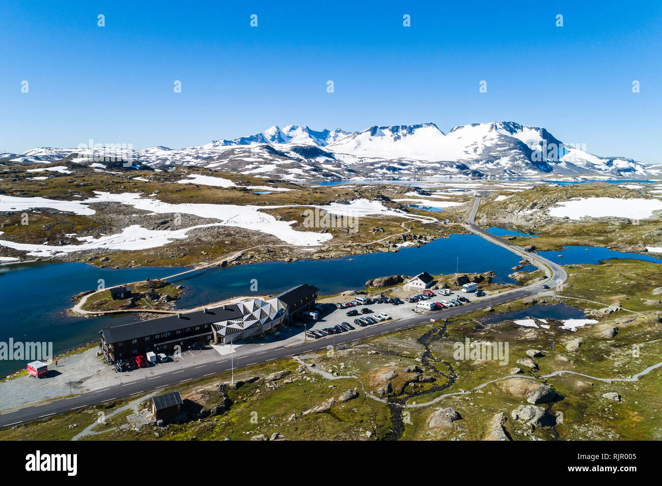 Lakeside skiing centre surrounded by rugged landscape and mountains, drone view, Sognefjell, Jotunheimen, Norway, Europe Stock Photo