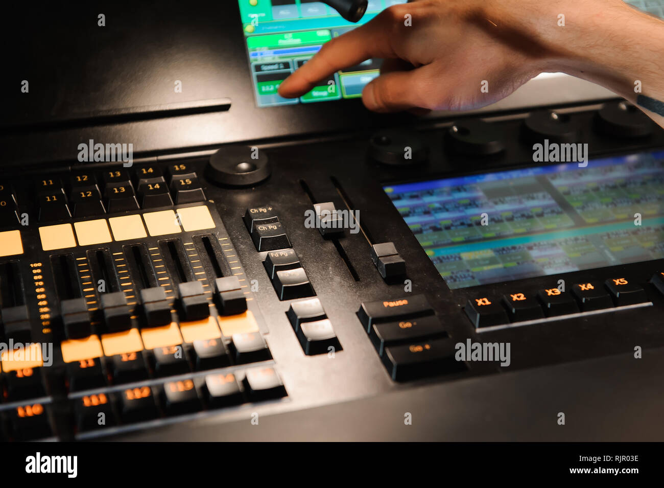 A lighting engineer works with lights technicians control Stock Photo