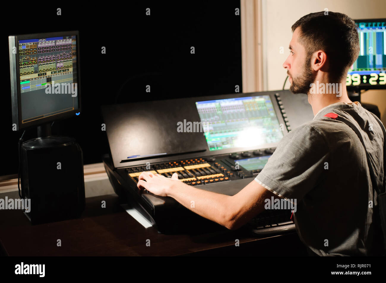 A lighting engineer works with lights technicians control Stock Photo ...