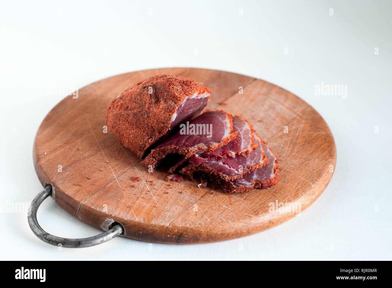 Dried beef. Sliced beef jerky. Meat on a wooden board. Stock Photo