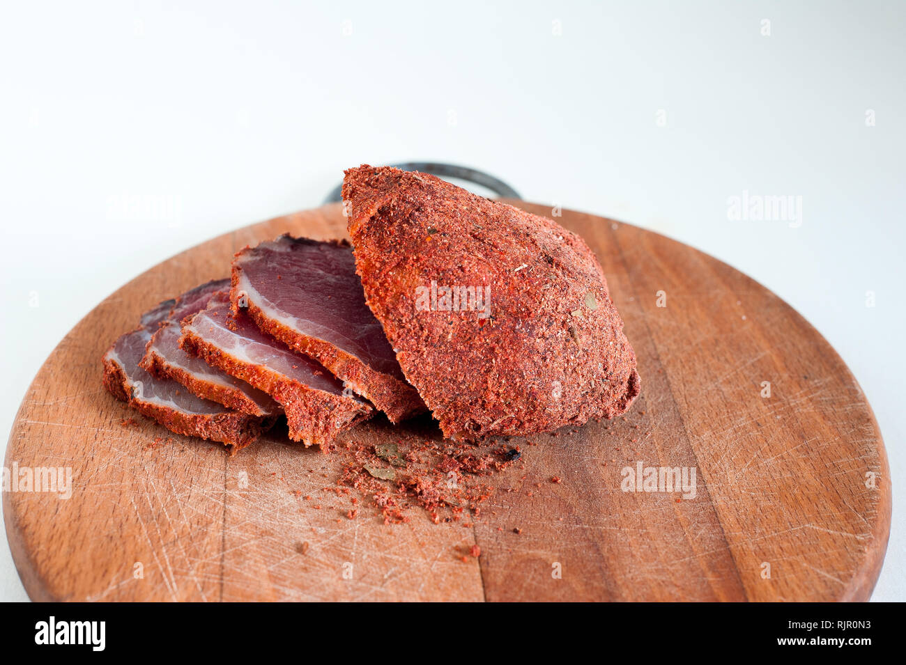 Dried beef. Sliced beef jerky. Meat on a wooden board. Stock Photo