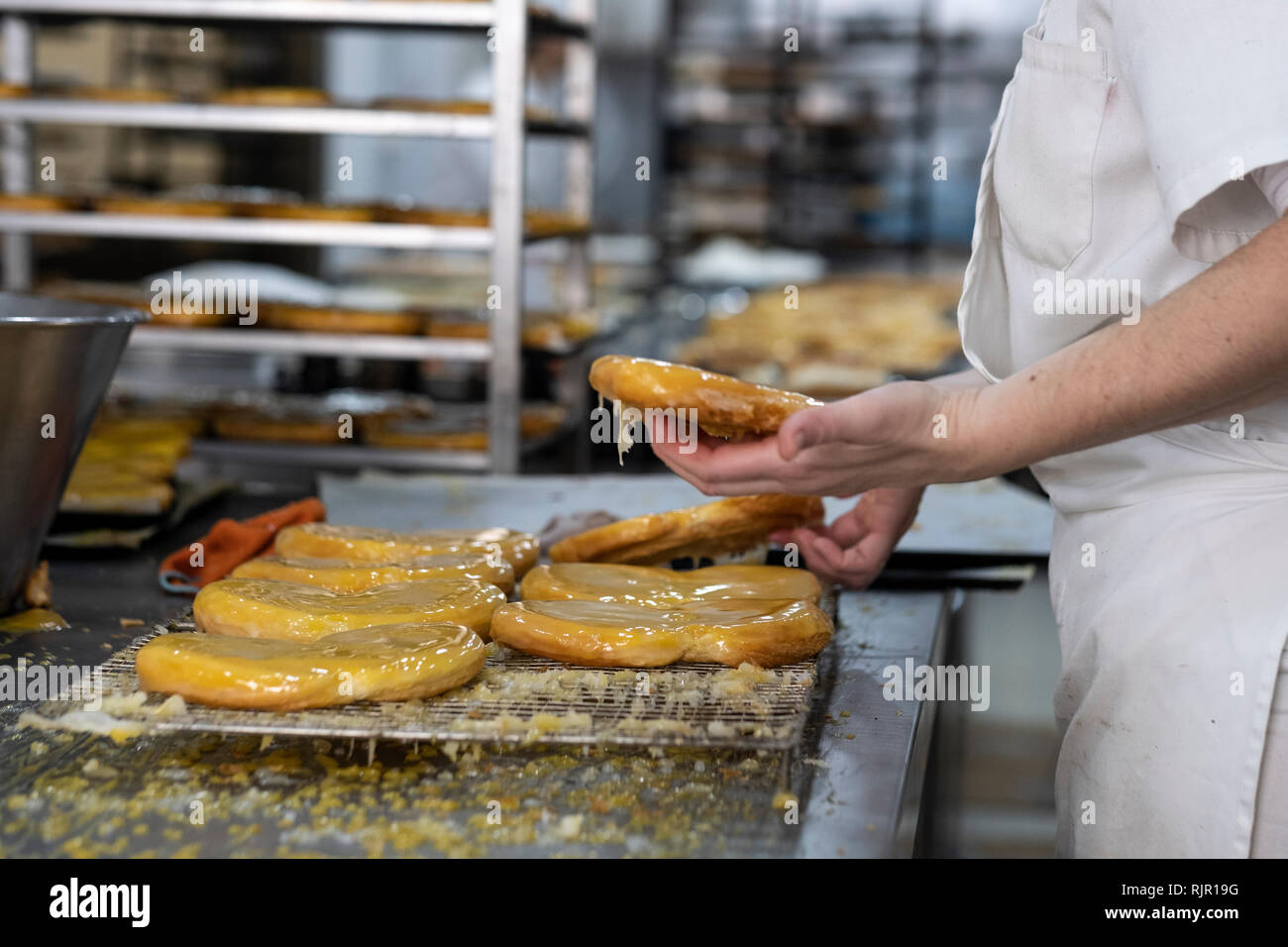 artisan pastry chef placing cake on tray Stock Photo