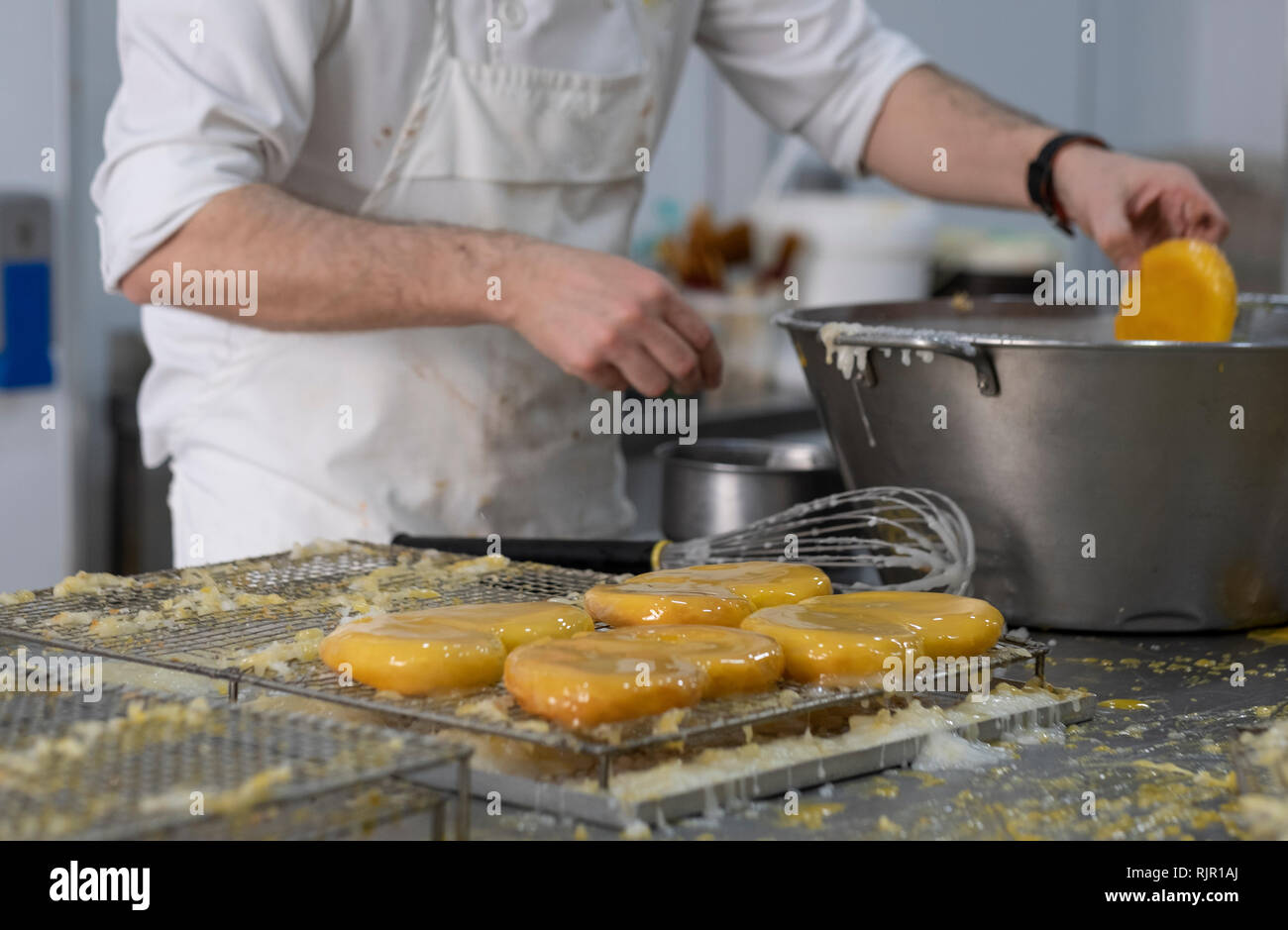 artisan pastry chef placing cake on tray Stock Photo