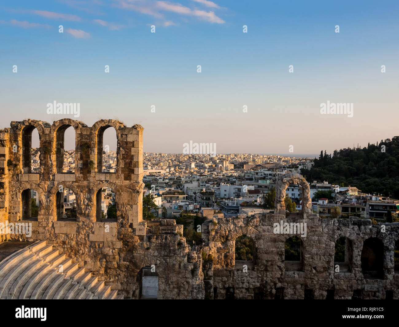 Odeon of Herodes Atticus arches and rows of seats of southern slope of Acropolis in Athens, Greece in soft light of a summer sunset Stock Photo