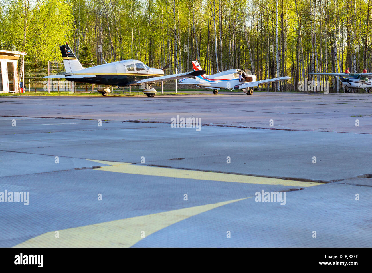 Light passenger planes parked before departure at private airport in Kronshtadt, St.Petersburg Russia. Industrial and civil air transportation by aircraft. Professional flights on airplanes Stock Photo