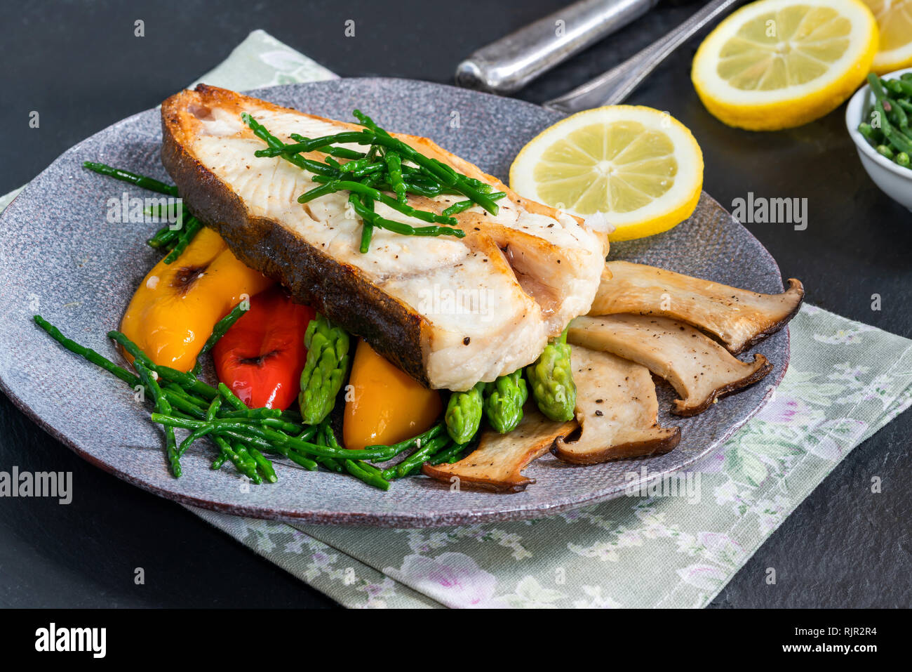 Grilled halibut steak with vegetables sweet mini peppers, courgette